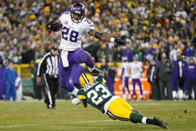 GREEN BAY, WI - JANUARY 03:  Adrian Peterson #28 of the Minnesota Vikings hurdles Damarious Randall #23 of the Green Bay Packers during the third quarter of their game at Lambeau Field on January 3, 2016 in Green Bay, Wisconsin.  (Photo by Wesley Hitt/Getty Images)