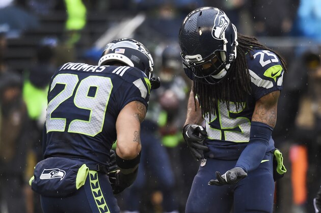 SEATTLE, WA - DECEMBER 27: Free safety Earl Thomas #29 and cornerback Richard Sherman #25 of the Seattle Seahawks play a little air guitar before the game against the St. Louis Rams at CenturyLink Field on December 27, 2015 in Seattle,Washington. (Photo by Steve Dykes/Getty Images)