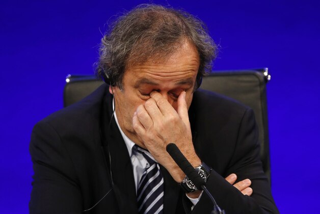 FILE - In this May 24, 2013 file photo UEFA President Michel Platini reacts as he speaks to members of the media at the end of the 37th Ordinary UEFA Congress in London.  (AP Photo/Sang Tan, file)
