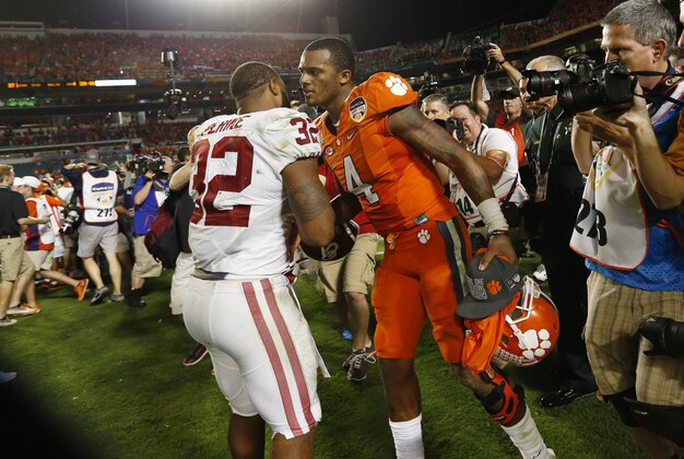 Dec 31, 2015; Miami Gardens, FL, USA; Oklahoma Sooners running back Samaje Perine (32) and Clemson Tigers quarterback Deshaun Watson (4) meet after the 2015 CFP Semifinal at the Orange Bowl at Sun Life Stadium. Clemson won 37-17. Mandatory Credit: Kim Klement-USA TODAY Sports