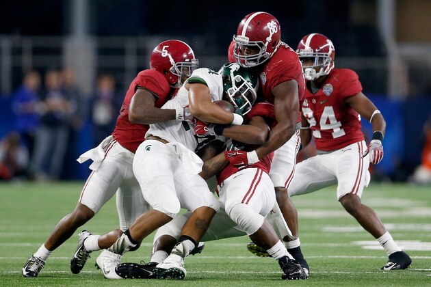 ARLINGTON, TX - DECEMBER 31:  Running back Gerald Holmes #24 of the Michigan State Spartans is tackled by defensive lineman A'Shawn Robinson #86 and Cyrus Jones #5 of the Alabama Crimson Tide during the Goodyear Cotton Bowl at AT&T Stadium on December 31, 2015 in Arlington, Texas.  (Photo by Ron Jenkins/Getty Images)