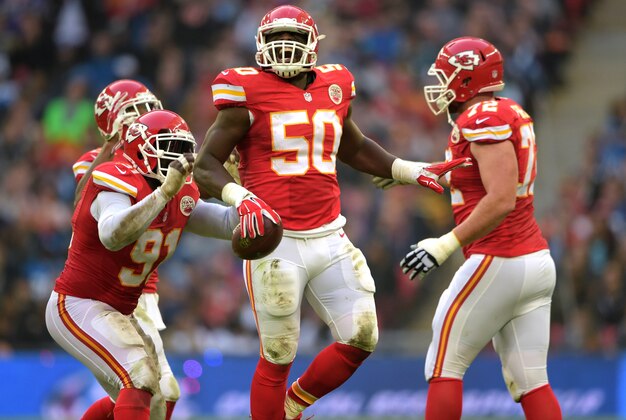 Nov 1, 2015; London, United Kingdom; Kansas City Chiefs linebacker Justin Houston (50) celebrates with teammates Tamba Hall (91) and Eric Fisher (72) after intercepting a pass in the second quarter against the Detroit Lions during game 14 of the NFL International Series at Wembley Stadium. Mandatory Credit: Kirby Lee-USA TODAY Sports