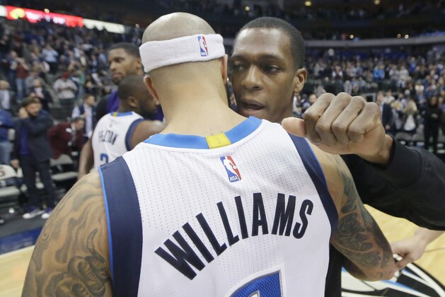 Dallas Mavericks guard Deron Williams gets a hug from Sacramento Kings guard Rajon Rondo after an NBA basketball game Tuesday, Jan. 5, 2016, in Dallas. The Mavericks won 117-116 in double overtime. (AP Photo/LM Otero)