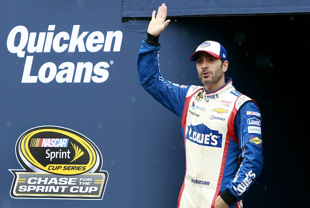 Jimmie Johnson waves to the crowd during driver introductions before the NASCAR Sprint Cup Series auto race at Phoenix International Raceway, Sunday, Nov. 15, 2015, in Avondale, Ariz. (AP Photo/Ralph Freso)