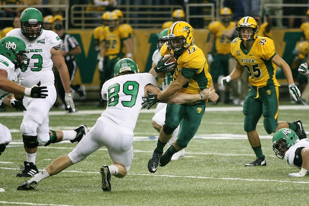 North Dakota State receiver Eric Perkins, right, eludes North Dakota defender Mitch Meindel, (89) during the second half of an NCAA college football game Saturday, Sept. 19, 2015, in Fargo, N.D.  North Dakota State won 34-9. (AP Photo/Bruce Crummy)
