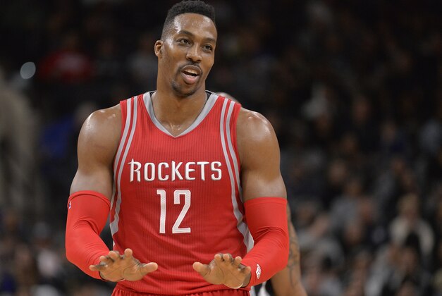 Houston Rockets center Dwight Howard gestures to players on the Houston bench during the second half of an NBA basketball game against the San Antonio Spurs, Saturday, Jan. 2, 2016, in San Antonio. San Antonio won 121-103. (AP Photo/Darren Abate)