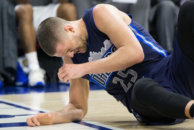 Nov 16, 2015; Philadelphia, PA, USA; Dallas Mavericks forward Chandler Parsons (25) falls to the floor after an elbow to his nose during the second quarter against the Philadelphia 76ers at Wells Fargo Center. Mandatory Credit: Bill Streicher-USA TODAY Sports