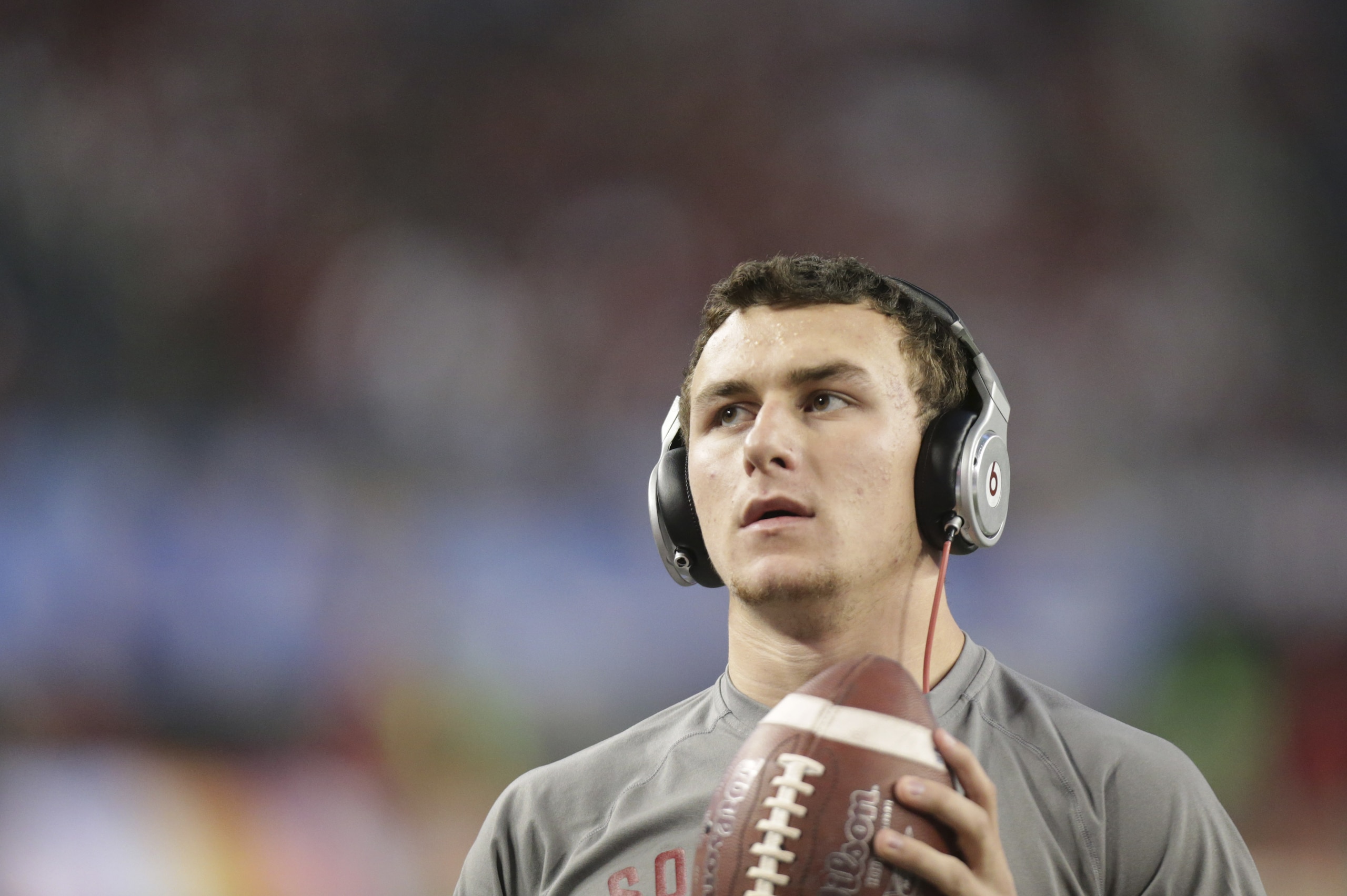 Texas A&M quarterback Johnny Manziel looks up as he warms up before the Cotton Bowl NCAA college football game against Oklahoma at Cowboys Stadium Friday, Jan. 4, 2013, in Irving, Texas. (AP Photo/LM Otero)