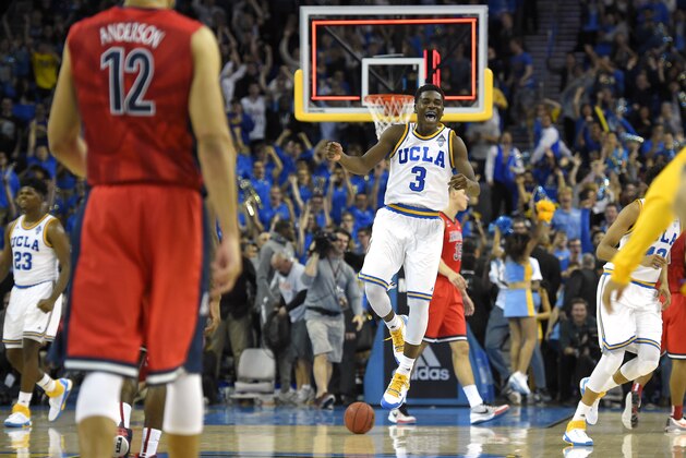 UCLA guard Aaron Holiday, center, celebrates as time runs out as Arizona forward Ryan Anderson, second from left, walks off the court after an NCAA college basketball game, Thursday, Jan. 7, 2016, in Los Angeles. UCLA won 87-84. (AP Photo/Mark J. Terrill)