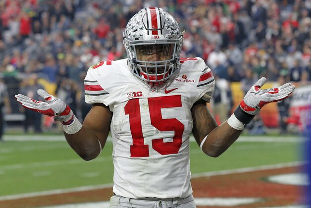 Ohio State running back Ezekiel Elliott (15) gestures as he celebrates his fourth touchdown of the game against Notre Dame  during the second half of the Fiesta Bowl NCAA College football game, Friday, Jan. 1, 2016, in Glendale, Ariz.  (AP Photo/Ross D. Franklin)