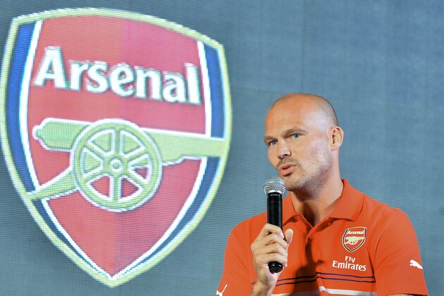 Former Arsenal footballer, Fredrick Ljungberg of Sweden takes part in an interactive session with fans during the launch of Arsenal Football Club kits in Bangalore on August 12, 2014. Fredrick, who is the brand ambassador for Arsenal Soccer Schools, launched sports brand Puma's Arsenal Home, Away And Cup Kits for 2014/15 football season in India.  AFP PHOTO/Manjunath KIRAN        (Photo credit should read Manjunath Kiran/AFP/Getty Images)
