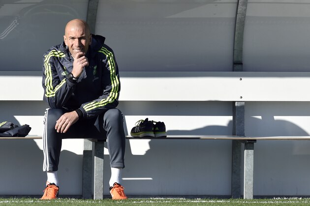 Real Madrid's new French coach Zinedine Zidane looks on as he sits on a bench during his first training session as coach of Real Madrid at the Alfredo di Stefano Stadium in Valdebebas, on the outskirts of Madrid, on January 5, 2016. Real Madrid legend Zinedine Zidane promised to put his 'heart and soul' into managing the Spanish giants after he was sensationally named as coach following Rafael Benitez's unceremonious sacking.   AFP PHOTO/ GERARD JULIEN / AFP / GERARD JULIEN        (Photo credit should read GERARD JULIEN/AFP/Getty Images)