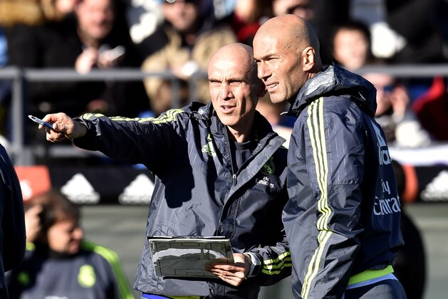 Real Madrid's new French coach Zinedine Zidane (R) listens to his French assistant coach David Bettoni during his first training session as coach of Real Madrid at the Alfredo di Stefano Stadium in Valdebebas, on the outskirts of Madrid, on January 5, 2016. Real Madrid legend Zinedine Zidane promised to put his 'heart and soul' into managing the Spanish giants after he was sensationally named as coach following Rafael Benitez's unceremonious sacking.   AFP PHOTO/ GERARD JULIEN / AFP / GERARD JULIEN        (Photo credit should read GERARD JULIEN/AFP/Getty Images)