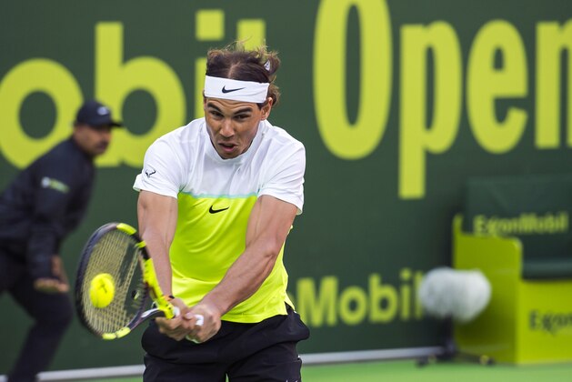 Spain's Rafael Nadal partnered by Fernando Verdasco of Spain, successfully returns the ball during the men's doubles match against Teymuraz Gabashvili of Russia and Albert Ramos of Spain at the Qatar Open in Doha, Qatar, Monday, Jan. 4, 2016. (AP Photo/Alexandra Panagiotidou)
