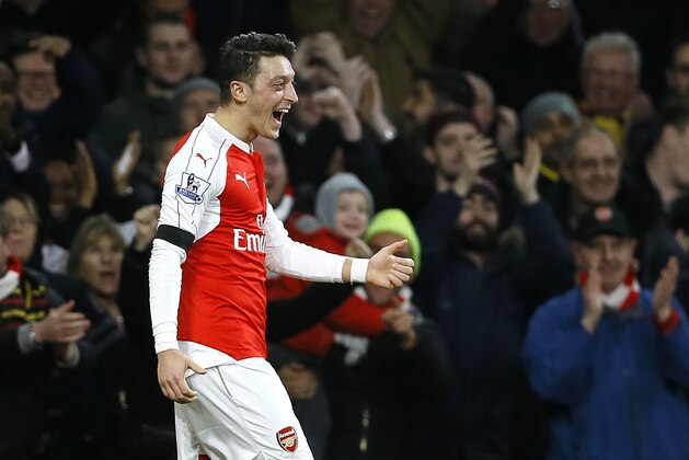Arsenal's Mesut Ozil celebrates after scoring a goal,  during the English Premier League soccer match between Arsenal and Bournemouth at Emirates stadium in London, Monday, Dec. 28, 2015. (AP Photo/Kirsty Wigglesworth)