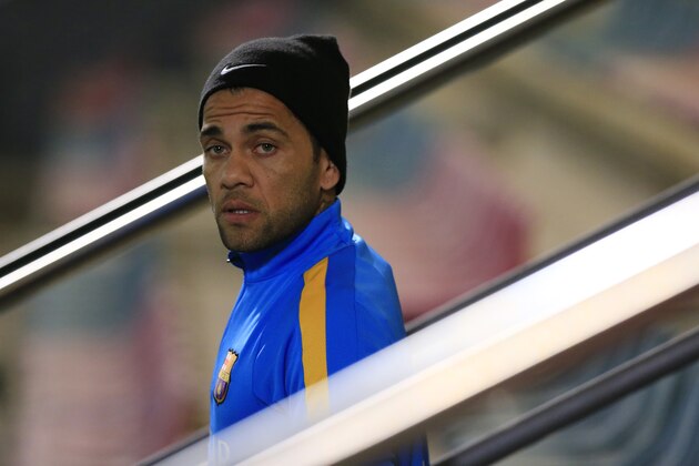 Barcelona's Brazilian defender Dani Alves looks on as he arrives at the first training session of the year at the Sports Center FC Barcelona Joan Gamper in Sant Joan Despi, near Barcelona on January 1, 2016.   AFP PHOTO/ PAU BARRENA / AFP / PAU BARRENA        (Photo credit should read PAU BARRENA/AFP/Getty Images)