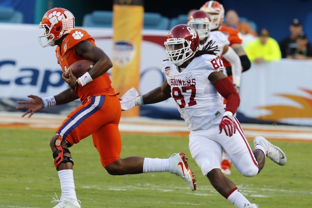 Clemson quarterback Deshaun Watson (4) carries the ball as Oklahoma defensive end D.J. Ward (87) pursues, during the first half of the Orange Bowl NCAA college football semifinal playoff game, Thursday, Dec. 31, 2015, in Miami Gardens, Fla. (AP Photo/Joe Skipper)