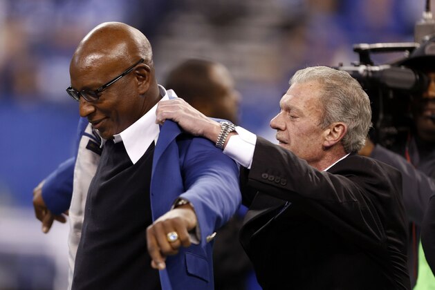 Dec 15, 2013; Indianapolis, IN, USA; Indianapolis Colts owner Jim Irsay presents Eric Dickerson a blue jacket as he is inducted into the Colts Ring of Honor at halftime of the game against the Houston Texans at Lucas Oil Stadium. Indianapolis defeats Houston 25-3. Mandatory Credit: Brian Spurlock-USA TODAY Sports