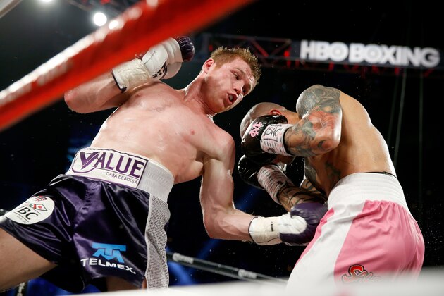 LAS VEGAS, NV - NOVEMBER 21:  (L-R)  Canelo Alvarez throws a left at Miguel Cotto during their middleweight fight at the Mandalay Bay Events Center on November 21, 2015 in Las Vegas, Nevada.  (Photo by Isaac Brekken/Getty Images)