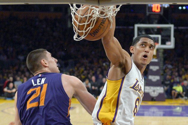 Los Angeles Lakers guard Jordan Clarkson, right, dunks as Phoenix Suns center Alex Len, of Ukraine, defends during the second half of an NBA basketball game, Sunday, Jan. 3, 2016, in Los Angeles. The Lakers won 97-77. (AP Photo/Mark J. Terrill)