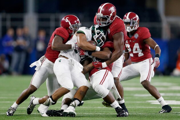 ARLINGTON, TX - DECEMBER 31: Running back Gerald Holmes #24 of the Michigan State Spartans is tackled by defensive lineman A'Shawn Robinson #86 and Cyrus Jones #5 of the Alabama Crimson Tide during the Goodyear Cotton Bowl at AT&T Stadium on December 31, 2015 in Arlington, Texas. (Photo by Ron Jenkins/Getty Images) ARLINGTON, TX - DECEMBER 31: Running back Gerald Holmes #24 of the Michigan State Spartans is tackled by defensive lineman A'Shawn Robinson #86 and Cyrus Jones #5 of the Alabama Crimson Tide during the Goodyear Cotton Bowl at AT&T Stadium on December 31, 2015 in Arlington, Texas. (Photo by Ron Jenkins/Getty Images)