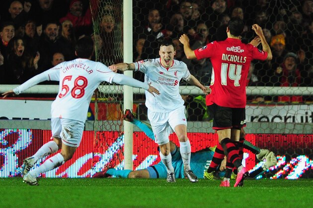 EXETER, ENGLAND - JANUARY 08:  Alex Nicholls of Exeter City (14) reacts as Brad Smith of Liverpool (C) celebrates scoring their second goal with Pedro Chirivella (68) during the Emirates FA Cup third round match between Exeter City and Liverpool at St James Park on January 8, 2016 in Exeter, England.  (Photo by Dan Mullan/Getty Images)