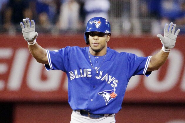 Toronto Blue Jays' Ben Revere celebrates a double against the Kansas City Royals during the first inning in Game 6 of baseball's American League Championship Series on Friday, Oct. 23, 2015, in Kansas City, Mo. (AP Photo/Charlie Riedel)