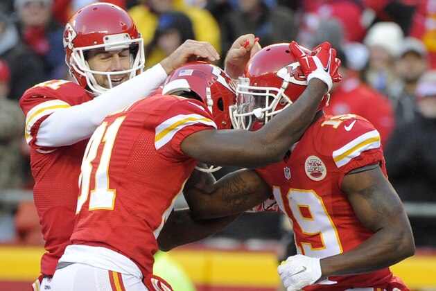 Kansas City Chiefs quarterback Alex Smith, left, and wide receiver Jason Avant, center, congratulate wide receiver Jeremy Maclin, right, following Maclin's touchdown against the Oakland Raiders during the first half of an NFL football game in Kansas City, Mo., Sunday, Jan. 3, 2016. (AP Photo/Ed Zurga)