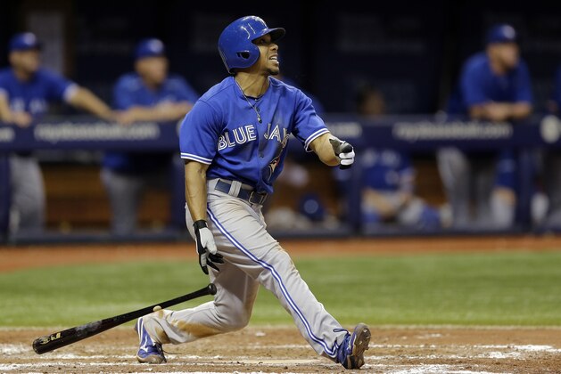 Toronto Blue Jays' Ben Revere hits an RBI  sacrifice fly off Tampa Bay Rays relief pitcher Enny Romero during the sixth inning of a baseball game Friday, Oct. 2, 2015, in St. Petersburg, Fla.  Blue Jays' Ryan Goins scored on the play. (AP Photo/Chris O'Meara)