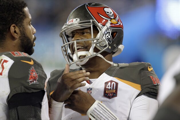 Tampa Bay Buccaneers' Austin Seferian-Jenkins (87) listens as Jameis Winston (3) talks to him on the sidelines during the second half of an NFL football game against the Carolina Panthers in Charlotte, N.C., Sunday, Jan. 3, 2016. The Panthers won 38-10. (AP Photo/Bob Leverone)