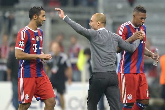 Bayern Munich's Spanish head coach Josep Guardiola  (C) congratulates  Bayern Munich's French defender Mehdi Benatia (L) and Bayern Munich's German defender Jerome Boateng  (R) after the UEFA Champions League Group E football match between FC Bayern Munich vs Manchester City at the Allianz Arena in Munich, southern Germany, on September 17, 2014. Munich won 1-0. AFP PHOTO / GUENTER SCHIFFMANN        (Photo credit should read GUENTER SCHIFFMANN/AFP/Getty Images)