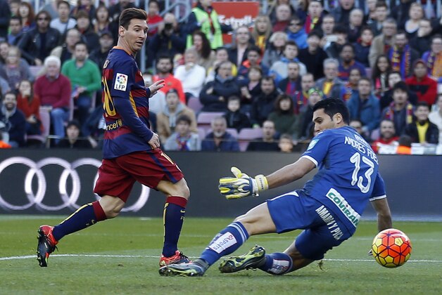 FC Barcelona's Lionel Messi, left, scores past Granada's goalkeeper Andres Fernandez during a Spanish La Liga soccer match between Barcelona and Grenada, at the Camp Nou stadium in Barcelona, Spain, Saturday, Jan. 9, 2016. (AP Photo/Manu Fernandez)