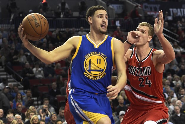 Golden State Warriors guard Klay Thompson (11) drives to the basket on Portland Trail Blazers center Mason Plumlee (24) during the first half of an NBA basketball game in Portland, Ore., Friday, Jan. 8, 2016. (AP Photo/Steve Dykes)
