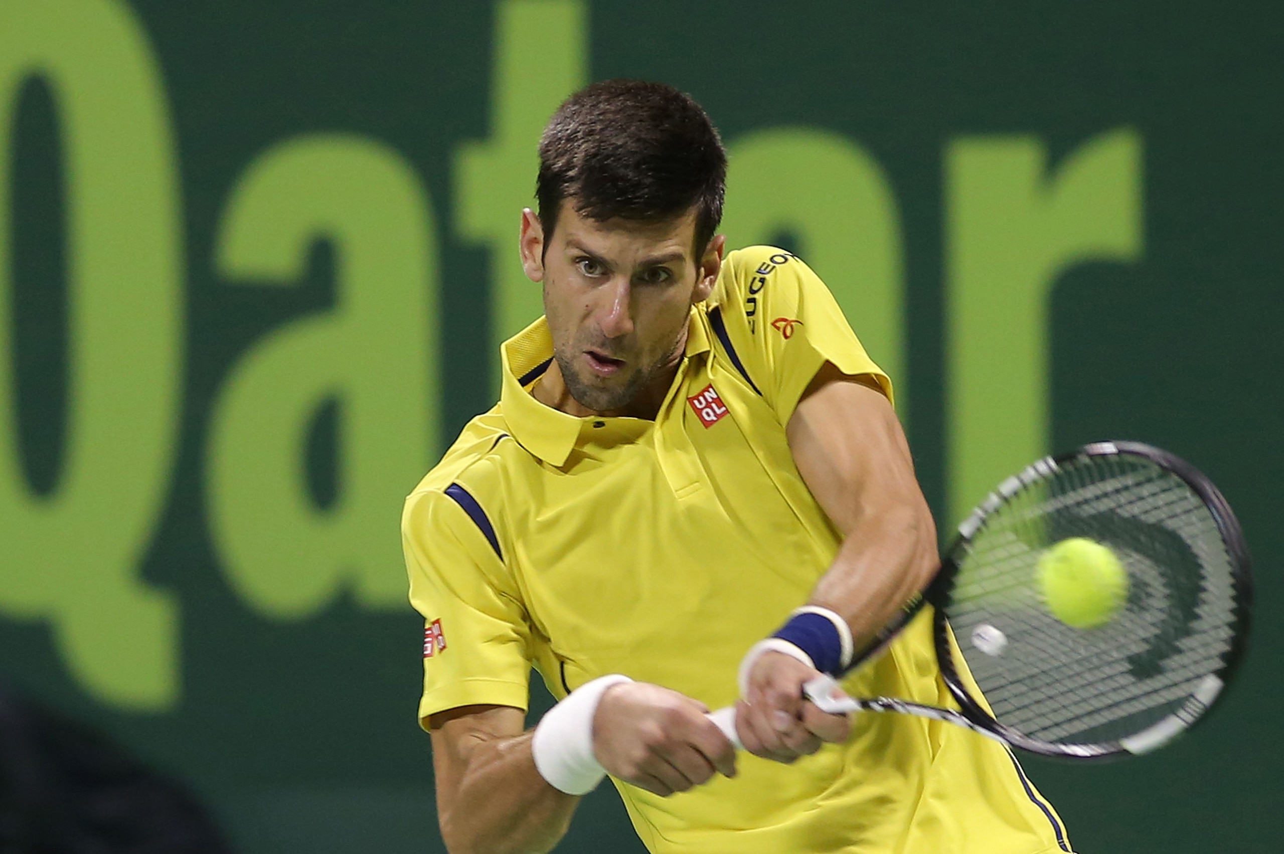 Novak Djokovic of Serbia returns the ball to Tomas Berdych of the Czech Republic during their semi-final tennis match in the Qatar Open tournament on January 8, 2016, in Doha. World number one Djokovic won the match 6-3, 7-6 (7/3). AFP PHOTO / KARIM JAAFAR / AFP / KARIM JAAFAR        (Photo credit should read KARIM JAAFAR/AFP/Getty Images)