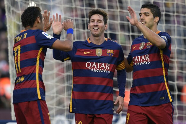 Barcelona's Argentinian forward Lionel Messi (C) celebrates a goal with Barcelona's Brazilian forward Neymar (L) and Barcelona's Uruguayan forward Luis Suarez (R) during the Spanish league football match FC Barcelona vs Granada CF at the Camp Nou stadium in Barcelona on January 9, 2016.   AFP PHOTO / LLUIS GENE / AFP / LLUIS GENE        (Photo credit should read LLUIS GENE/AFP/Getty Images)