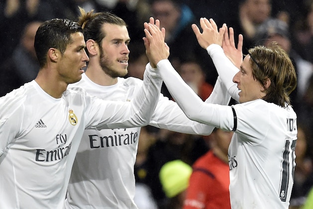 Real Madrid's Welsh forward Gareth Bale (C) is congratulated by Real Madrid's Portuguese forward Cristiano Ronaldo (L) and Real Madrid's Croatian midfielder Luka Modric after scoring during the Spanish league football match Real Madrid CF vs RC Deportivo La Coruna at the Santiago Bernabeu stadium in Madrid on January 9, 2016.  AFP PHOTO / GERARD JULIEN / AFP / GERARD JULIEN        (Photo credit should read GERARD JULIEN/AFP/Getty Images)