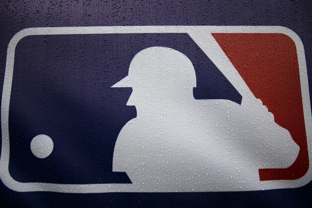 Rain drops cover the Major League Baseball logo before the start of Game 3 of the American League baseball championship series between the Baltimore Orioles and the Kansas City Royals Monday, Oct. 13, 2014, in Kansas City, Mo. The Royals lead the series 2-0. (AP Photo/Matt Slocum )