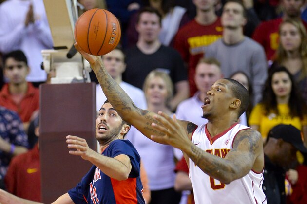 Arizona forward Mark Tollefsen, left, and Southern California forward Darion Clark (0) fight for the ball during the first half of an NCAA college basketball game, Saturday, Jan. 9, 2016, in Los Angeles. (AP Photo/Gus Ruelas)