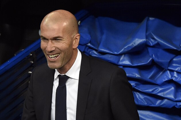 Real Madrid's new French coach Zinedine Zidane smiles as he arrives at the pitch before the Spanish league football match Real Madrid CF vs RC Deportivo La Coruna at the Santiago Bernabeu stadium in Madrid on January 9, 2016.  AFP PHOTO / GERARD JULIEN / AFP / GERARD JULIEN        (Photo credit should read GERARD JULIEN/AFP/Getty Images)