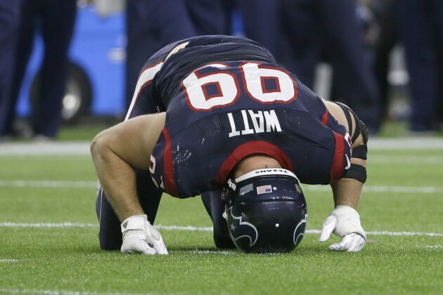 Houston Texans defensive end J.J. Watt (99) holds his head to the turf after he was injured during the second half of an NFL wild-card playoff football game against the Kansas City Chiefs, Saturday, Jan. 9, 2016, in Houston. (AP Photo/Tony Gutierrez)