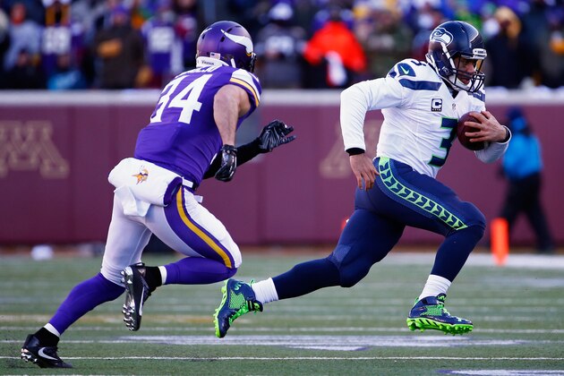 MINNEAPOLIS, MN - JANUARY 10:  Russell Wilson #3 of the Seattle Seahawks runs with the ball as Andrew Sendejo #34 of the Minnesota Vikings defends him in the second quarter during the NFC Wild Card Playoff game at TCFBank Stadium on January 10, 2016 in Minneapolis, Minnesota.  (Photo by Jamie Squire/Getty Images)