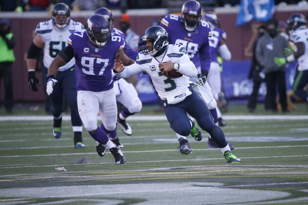 Seattle Seahawks quarterback Russell Wilson (3) runs past Minnesota Vikings offensive guard Michael Harris (79) during the second half of an NFL wild-card football game, Sunday, Jan. 10, 2016, in Minneapolis. (AP Photo/Jim Mone)