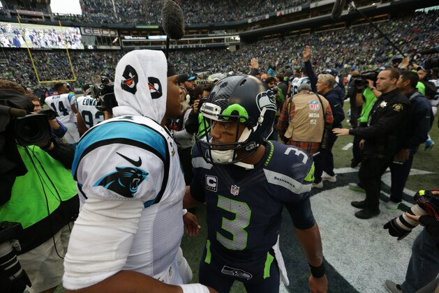 Carolina Panthers quarterback Cam Newton, left, shakes hands with Seattle Seahawks quarterback, Russell Wilson, right, after an NFL football game, Sunday, Oct. 18, 2015, in Seattle. The Panthers beat the Seahawks 27-23.  (AP Photo/Ryan Kang)