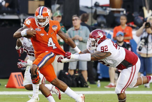 Clemson quarterback Deshaun Watson (4) runs with the ball as Oklahoma defensive tackle Matthew Romar (92) attempts to stop him, during the first half of the Orange Bowl NCAA college football semifinal playoff game, Thursday, Dec. 31, 2015, in Miami Gardens, Fla. (AP Photo/Joe Skipper) Clemson quarterback Deshaun Watson (4) runs with the ball as Oklahoma defensive tackle Matthew Romar (92) attempts to stop him, during the first half of the Orange Bowl NCAA college football semifinal playoff game, Thursday, Dec. 31, 2015, in Miami Gardens, Fla. (AP Photo/Joe Skipper)