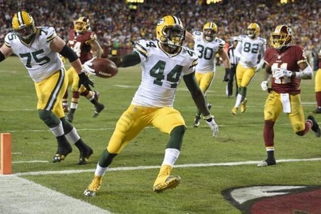 Green Bay Packers running back James Starks (44) carries the ball into the end zone for a touchdown as Washington Redskins cornerback Will Blackmon (41) watches during the second half of an NFL wild card playoff football game in Landover, Md., Sunday, Jan. 10, 2016. (AP Photo/Nick Wass)