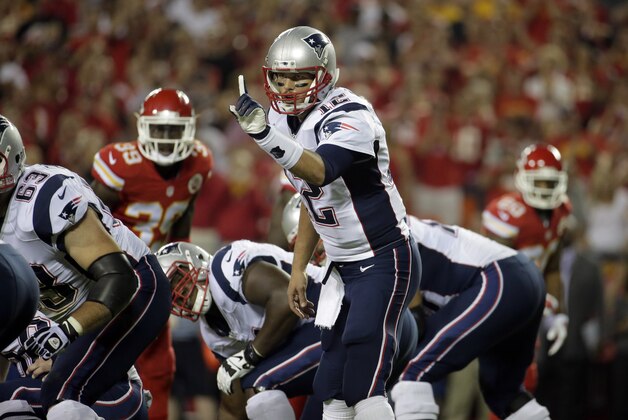 New England Patriots quarterback Tom Brady points on the line of scrimmage during the first quarter of an NFL football game against the Kansas City Chiefs Monday, Sept. 29, 2014, in Kansas City, Mo. (AP Photo/Charlie Riedel)