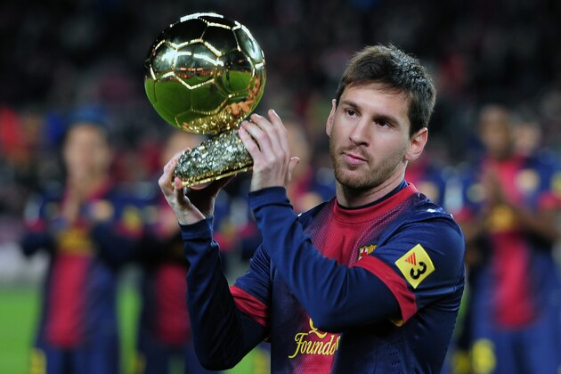 Barcelona's Argentinian forward Lionel Messi holds his 4th FIFA Ballon d'Or trophy prior to the Spanish Copa del Rey (King's Cup) quarter-final football match FC Barcelona vs Malaga CF at the Camp Nou stadium in Barcelona on January 16, 2013.     AFP PHOTO/ LLUIS GENE        (Photo credit should read LLUIS GENE/AFP/Getty Images)