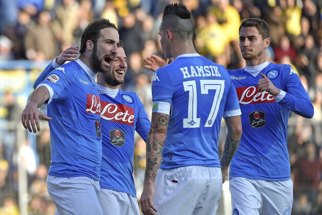 Napoli's Gonzalo Higuain, left, celebrates with his teammates after he scored on a penalty kick during a Serie A soccer match between Frosinone and Napoli, in Frosinone, Italy, Sunday, Jan. 10, 2016. (Ettore Ferrari/ANSA via AP)
