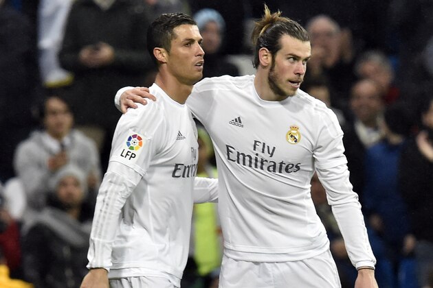 Real Madrid's Welsh forward Gareth Bale (R) celebrates a goal with Real Madrid's Portuguese forward Cristiano Ronaldo during the Spanish league football match Real Madrid CF vs RC Deportivo La Coruna at the Santiago Bernabeu stadium in Madrid on January 9, 2016.  AFP PHOTO / GERARD JULIEN / AFP / GERARD JULIEN        (Photo credit should read GERARD JULIEN/AFP/Getty Images)