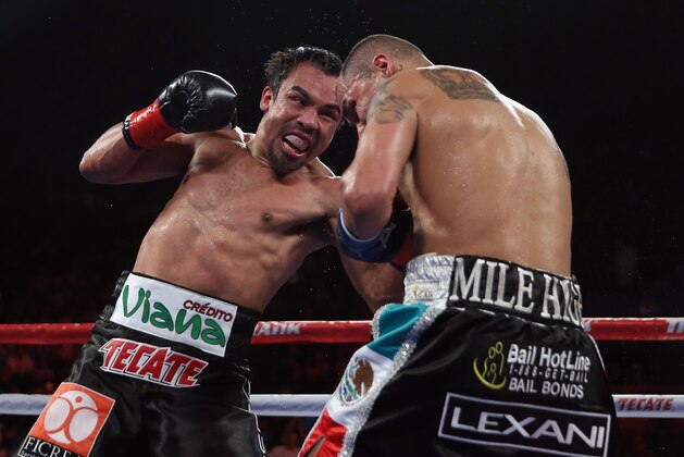 INGLEWOOD, CA - MAY 17:  Juan Manuel Marquez (L) prepares to throw a right hand at Mike Alvarado at The Forum on May 17, 2014 in Inglewood, California.  (Photo by Jeff Gross/Getty Images)